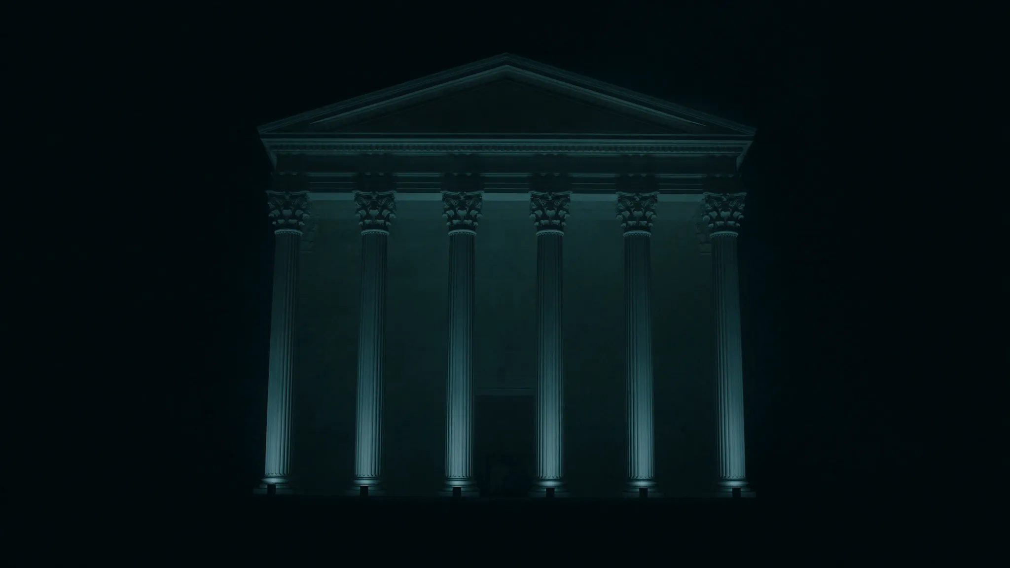 A neoclassical civic colonnade lit from below at night